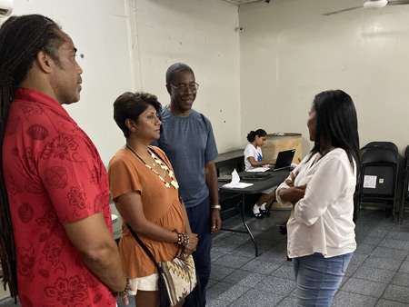 Dr. Malini Saba interacting with an official at a Boys and Girls club in Belize